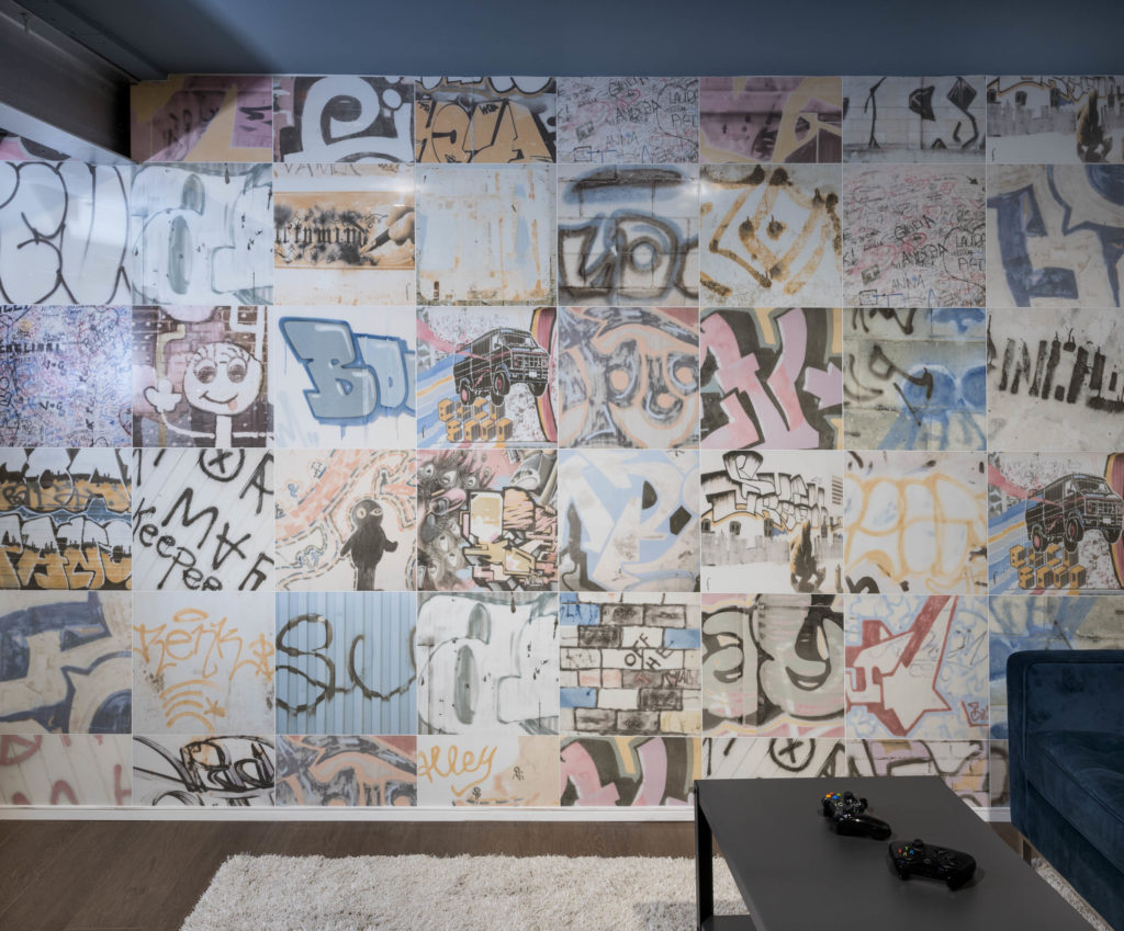 Graffiti wall and shag rug with blue velvet couch