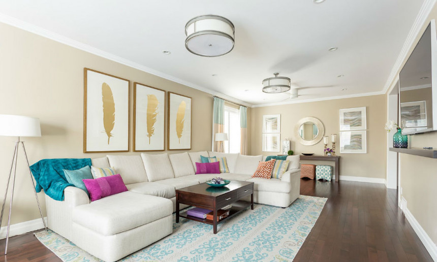 living-room-with-hardwood-flooring-teal-and-white-rug-and-cream-sectional