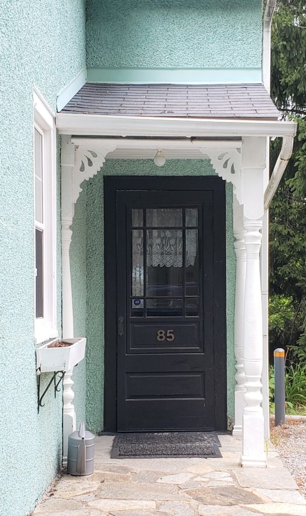 Wedgwood Blue House And Black Shutters And Black Door Close Up