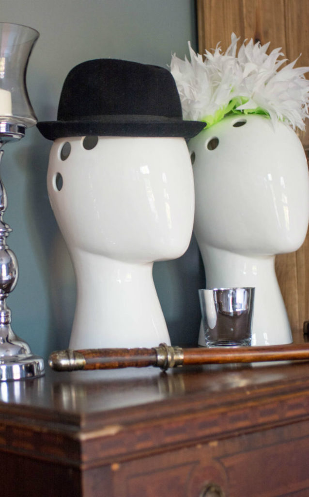 Decorative Mannequin Heads With Hat Feathers On Wooden Chest In Bedroom