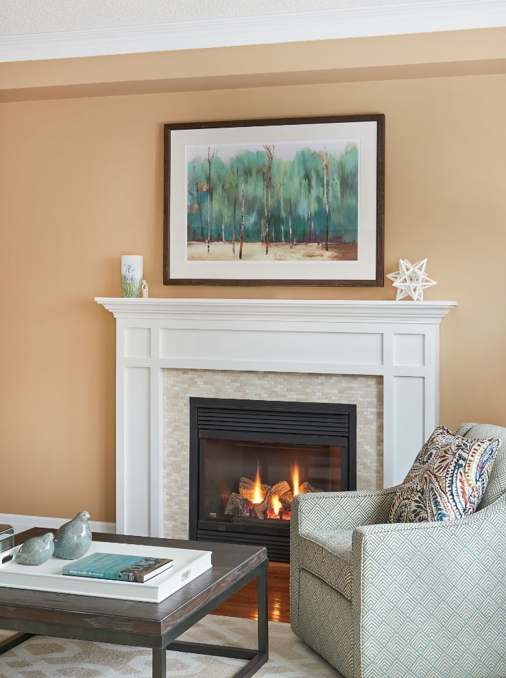 Living Room With Swivel Chair By Fireplace With White Mantle 1