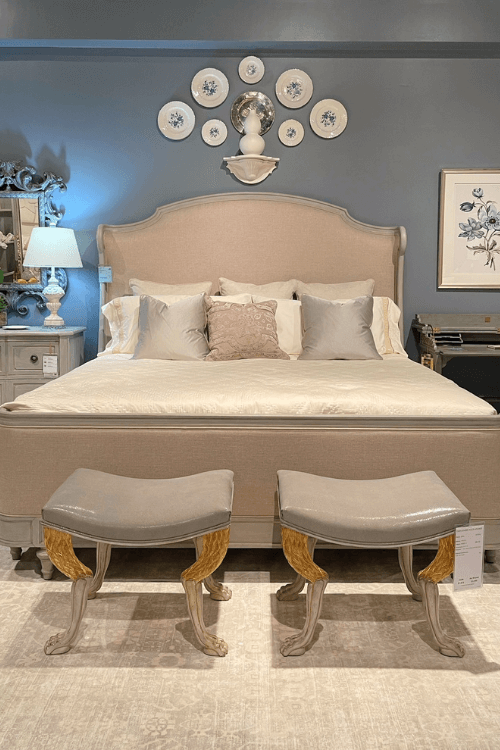 blue wall principle bedroom, blue bedroom wall, neutral bedroom, gray stools
