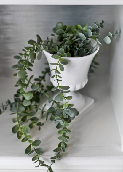 green-trailing-plant-in-white-milk-glass-jar