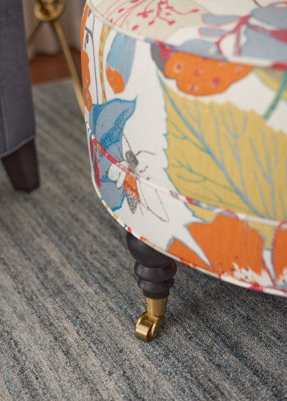 round-ottoman-upholstered-kravet-fabric-colorful-pattern-brass-castors