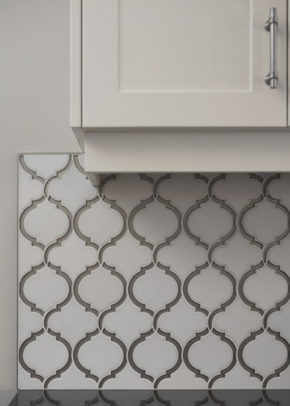 white-backsplash-tile-morrocan-pattern-white-kitchen-cabinetry