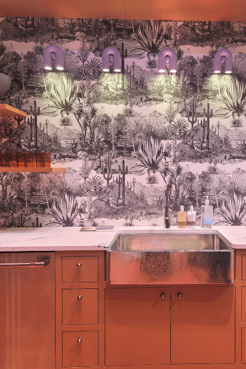 terracotta cabinetry, hammered sink, black and white wallpaper