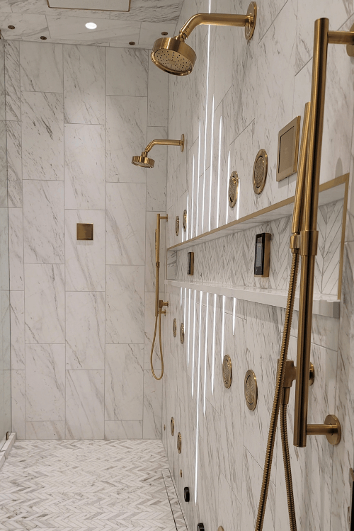 New American Home, marble shower, brass hardware, statement lighting