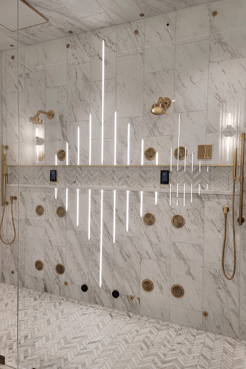 marble tile, shower lighting, brass shower head, brass fixtures