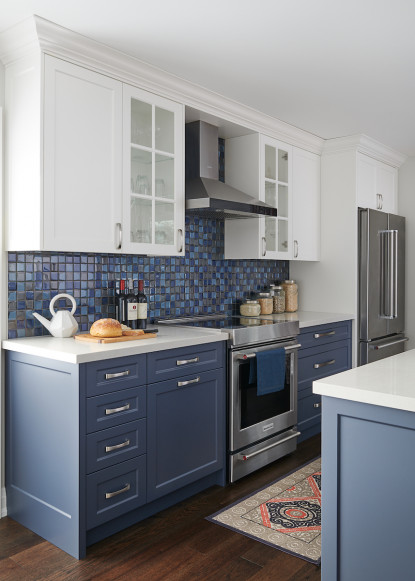 blue-and-white-kitchen-gray-counters-dark-hardwood-flooring-glass-cabinets