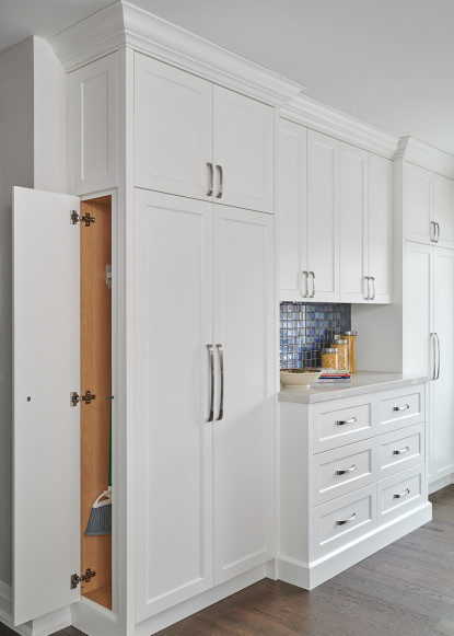 hidden-storage-brooms-white-kitchen-pantry-shaker-doors-dark-hardwood