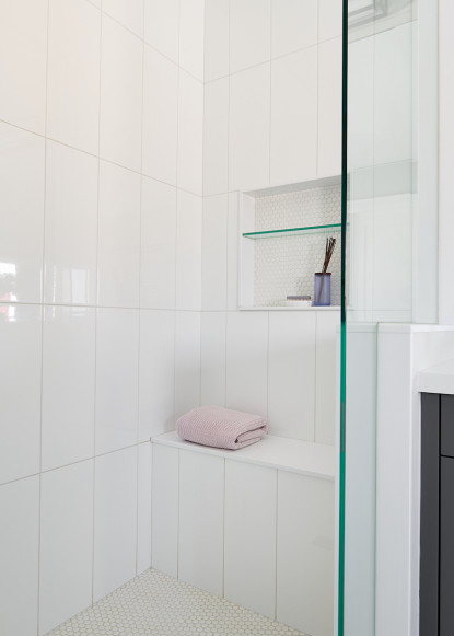 white-tile-glass-shower-door-shower-niche-penny-round-tile-bathroom-bench-seat