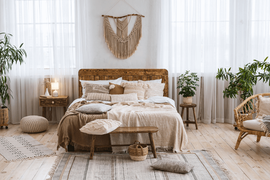 light wood flooring, natural flooring, wood bed frame, macramé, cane chair, wicker chair, layered design, plants