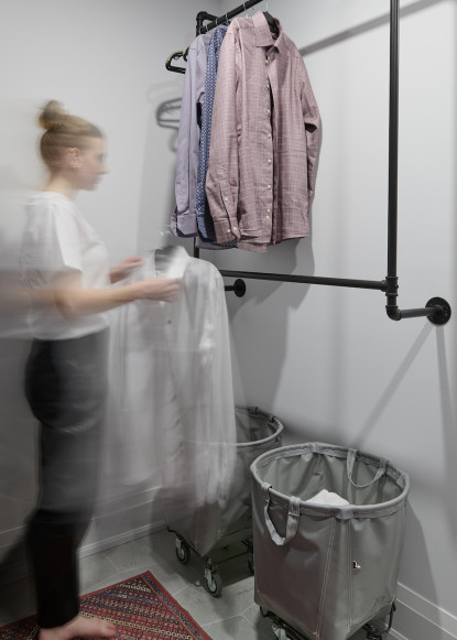 laundry-room-organization-black-piping-hanger-laundry-basekets-on-wheels-chatilly-lace-benjamin-moore