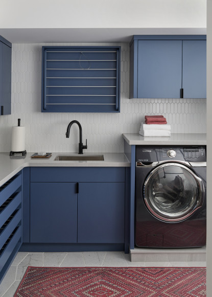 organized-laundry-room-blue-cabinets-indigogo-benjamin-moore-black-hardware-black-faucet
