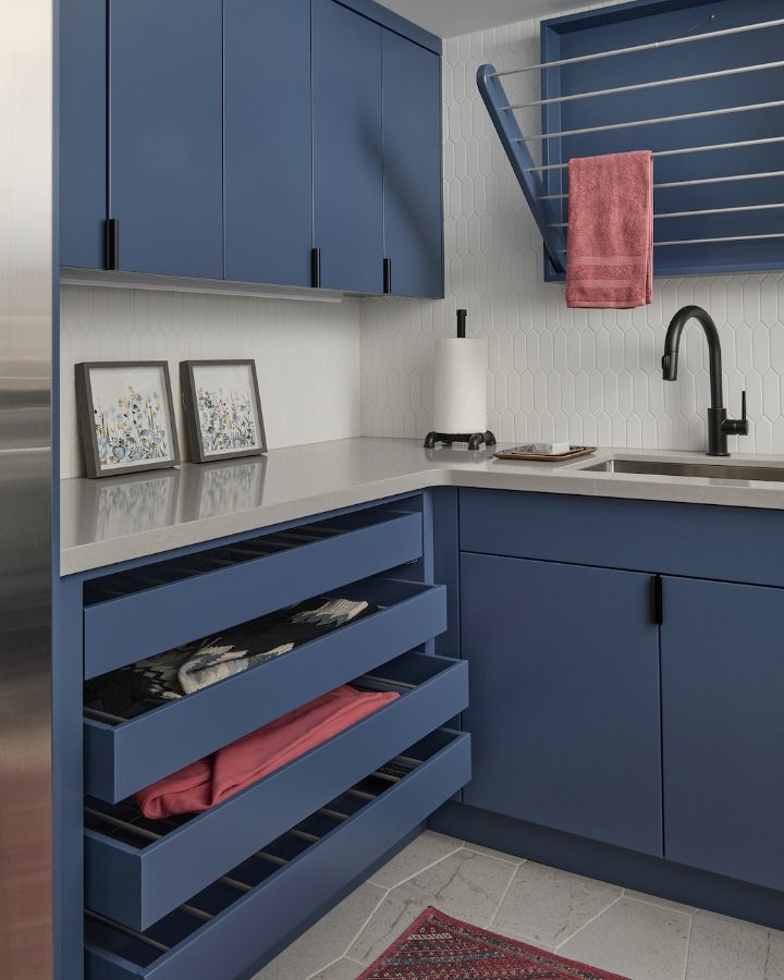 Custom Laundry Room Blue Cabinets Pull Out Drying Rack Drawers Quartz Countertops Gray Flooring