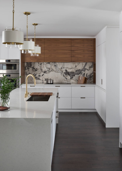 white-kitchen-design-with-walnut-accents-quartzite-backsplash-gold-faucet