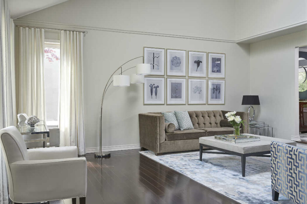 Living Room With Benjamin Moore Classic Gray With Gallery Wall And Tri Lamp. Featuring Warm Classy Seating And Ripple Drapery